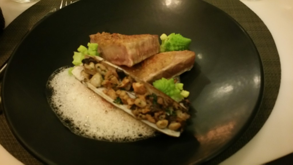 Tuna crusted with walnuts on a bed of shitaki mushrooms served with diced razor clam