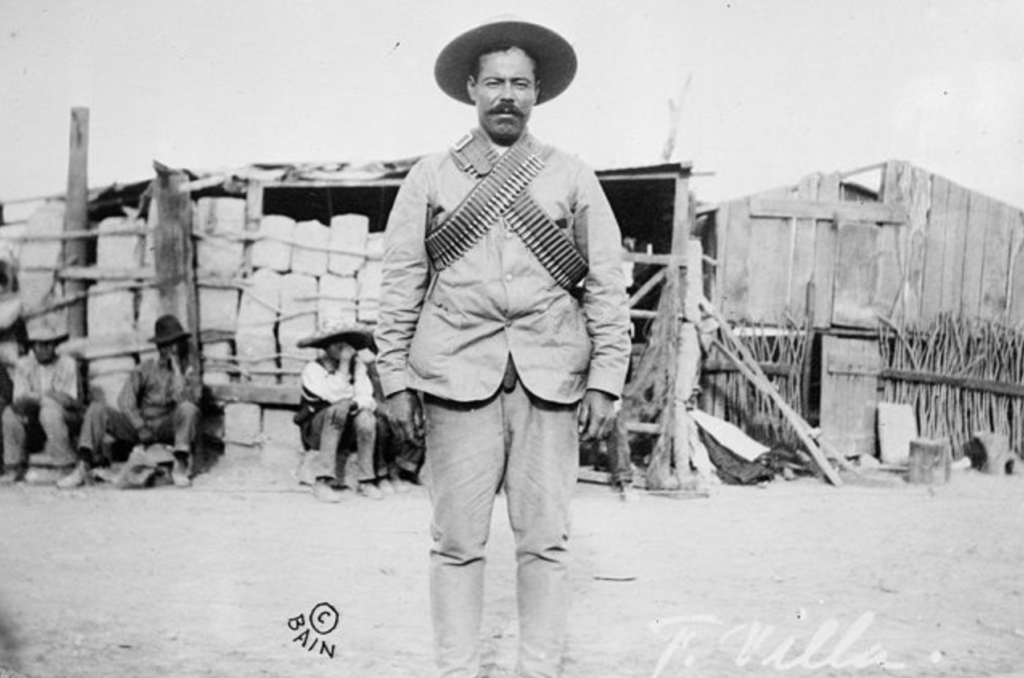 Francisco "Pancho" Villa (1877–1923), Mexican revolutionary general, wearing bandoliers in front of an insurgent camp. - Library of Congress
