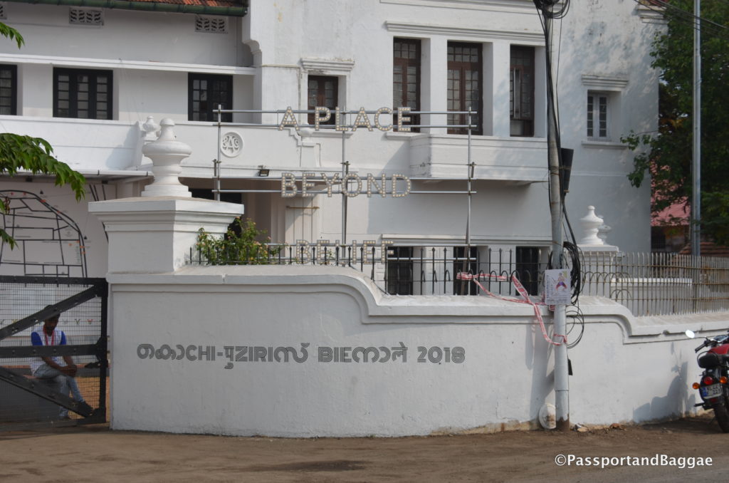 A piece by Nathan Coley popping up behind the Aspinwall House in Cochin