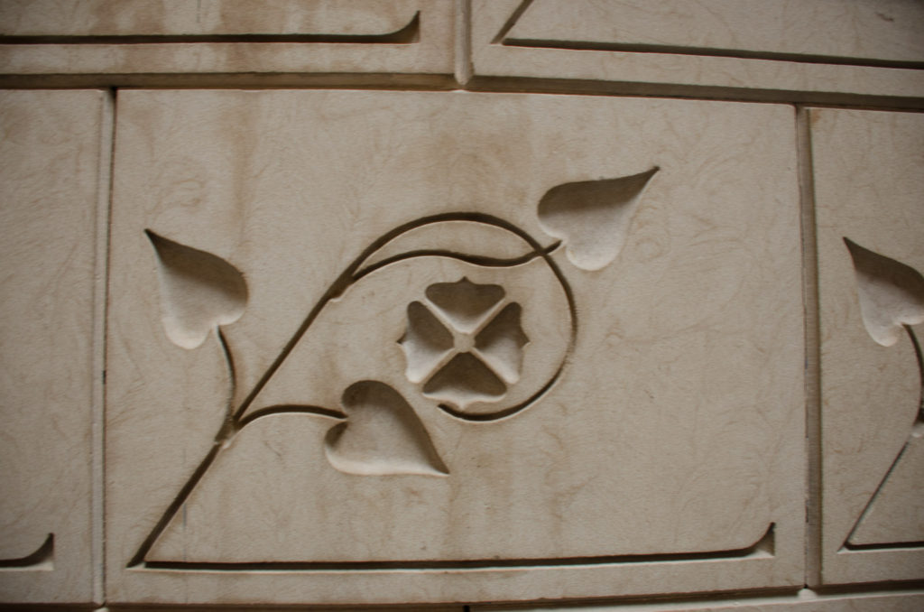 The walls of the stairway are lined with these sandblasted flowers.